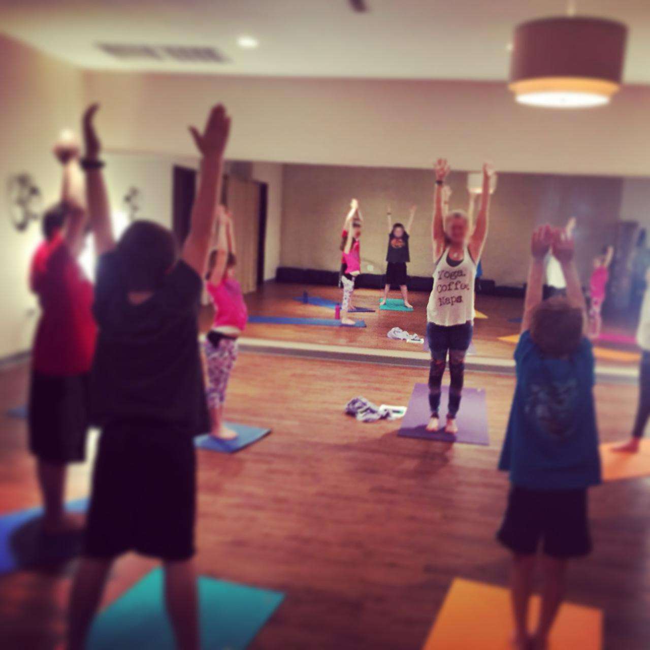 The Zin Yoga Studio — warm wood floors, colorful mats, and the space where camp comes alive